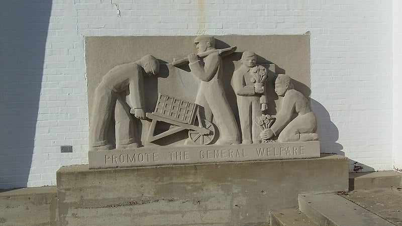 Sculpture reading "promote the general welfare"