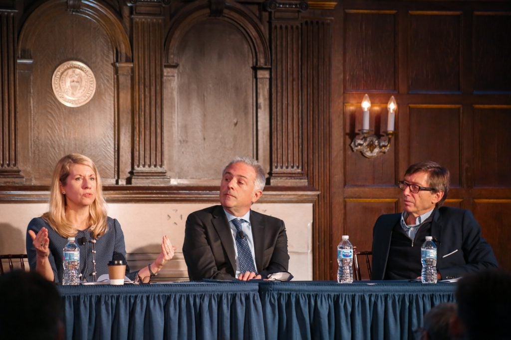 image of three participants in the symposium sitting at a head table