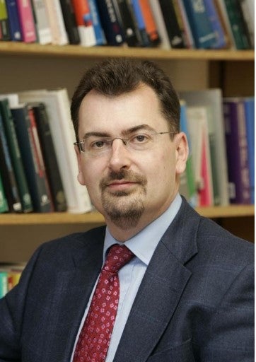 profile photo of Colin Scott in front of bookcase