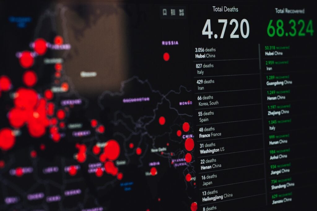 Black screen with covid-19 death statistics and a map.