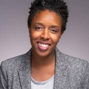 headshot of Chante Mouton Kinyon looking into the camera, framed against a gray background.