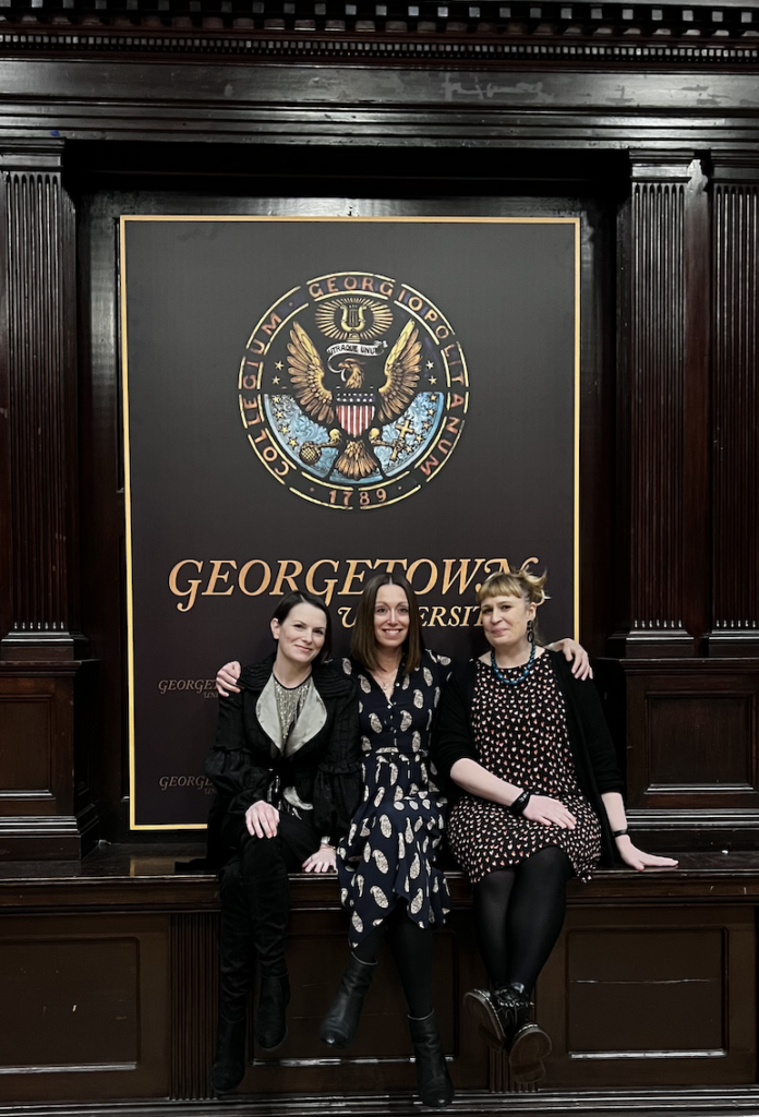 picture from left to right of: Michelle Gallen, Lucy Caldwell, and Jan Carson seated in front of a Georgetown University insignia.