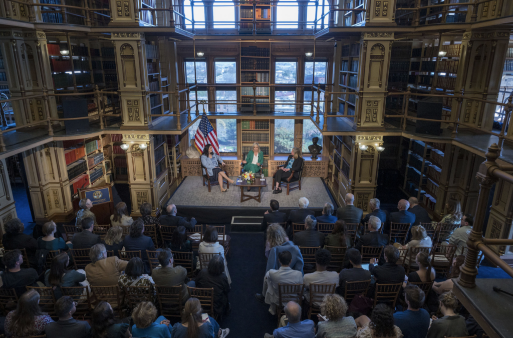 overhead view of Riggs library looking over audience members and seated speakers.